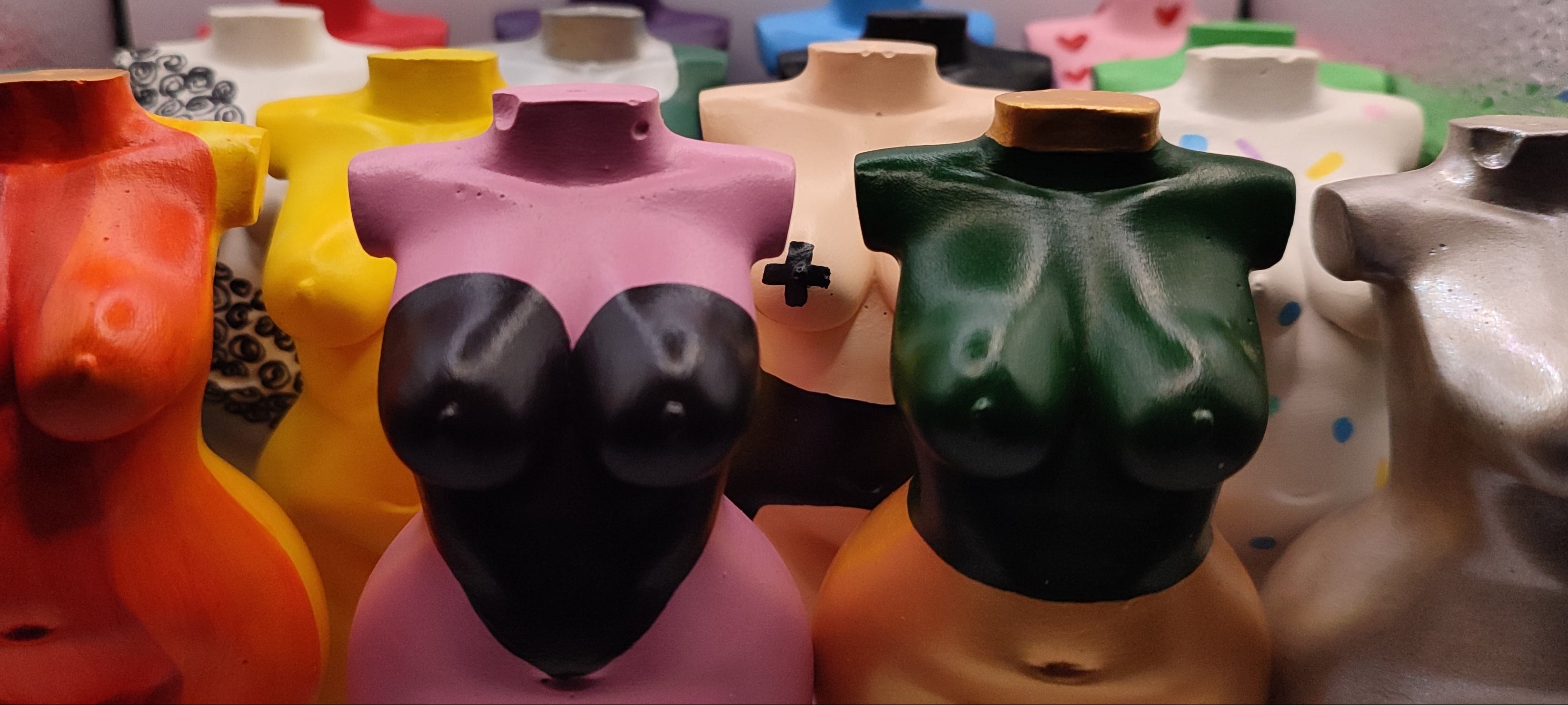 Colorful ceramic woman-shaped vases formed as an army